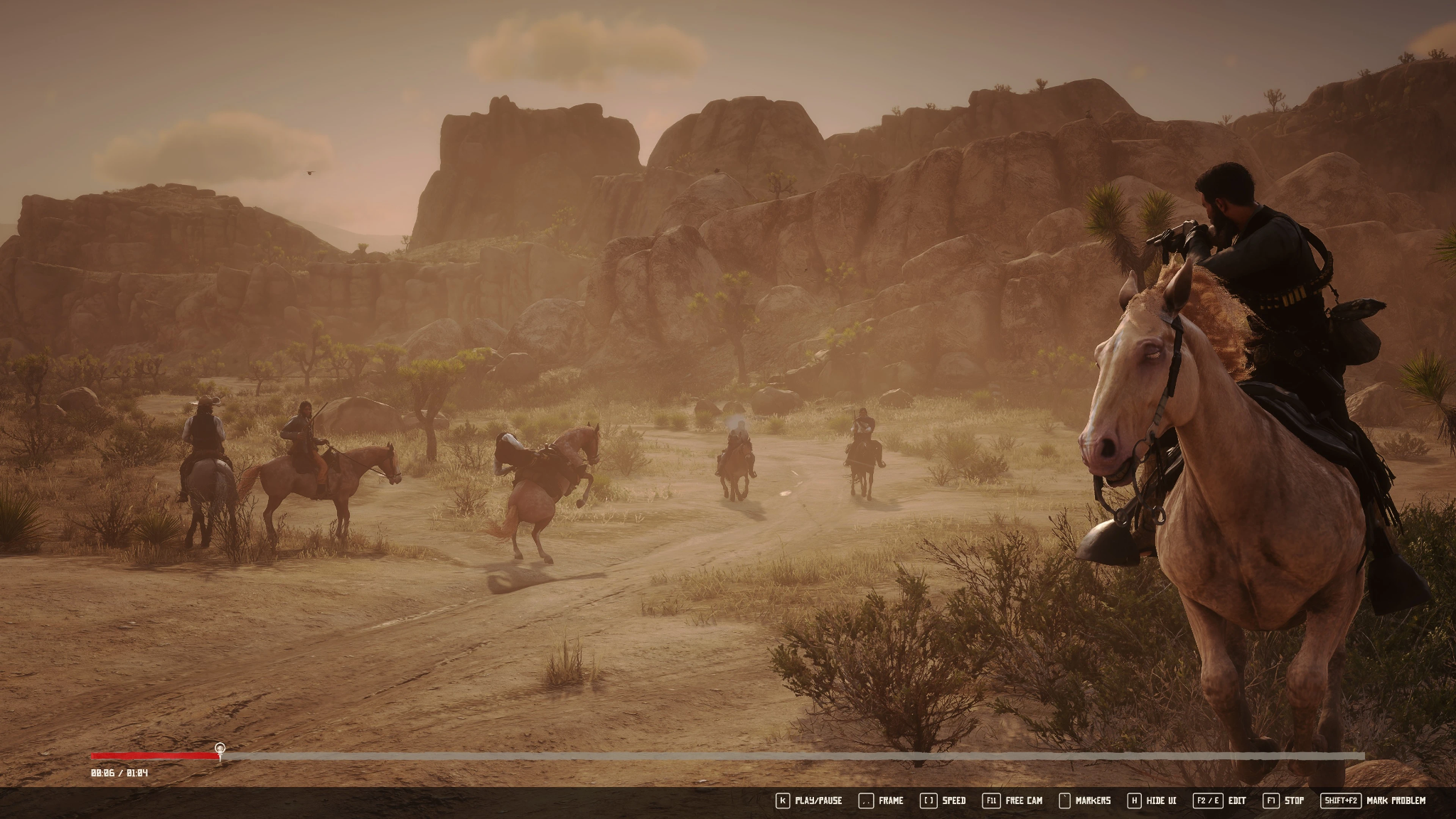 Arthur aims a revolver from horseback during a shootout in a sunlit desert, with Redemption Editor playback controls visible.